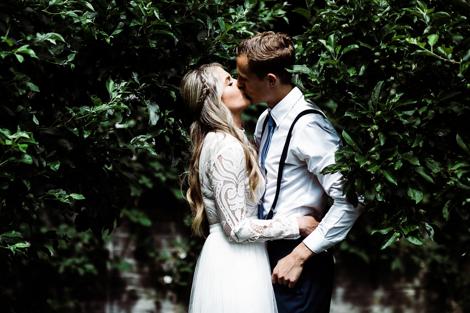 Bride and groom kissing in their garden